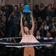 An outfit descends from the ceiling to dress one of the models.